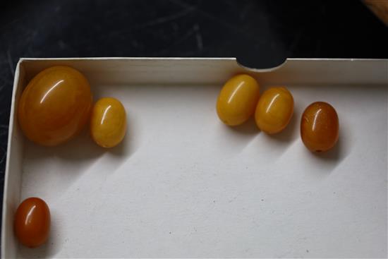 A large single strand graduated oval amber bead necklace,